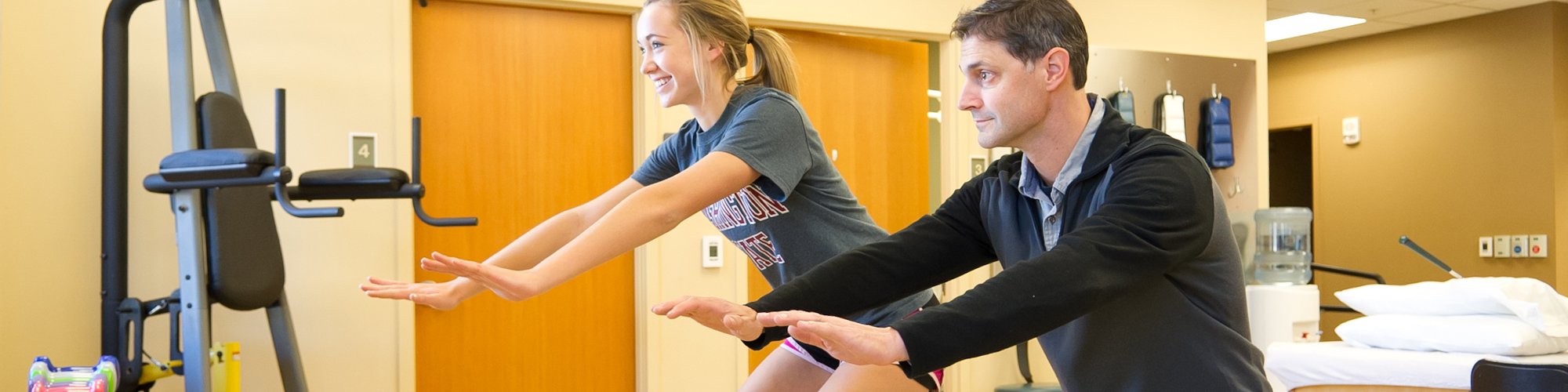 Physical Therapist Chris Allen works with Makenna, a high school athlete.