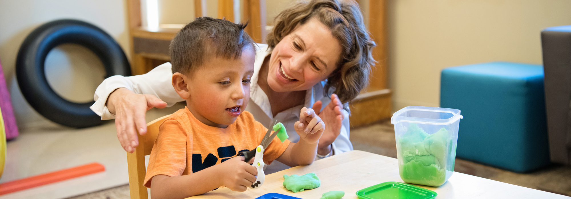 Pediatric occupational therapist Sarah Peery helps a child with fine motor skills.