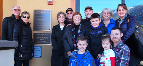 The extended Adamson family stand in front of a plaque dedicated to the late Jim Adamson.