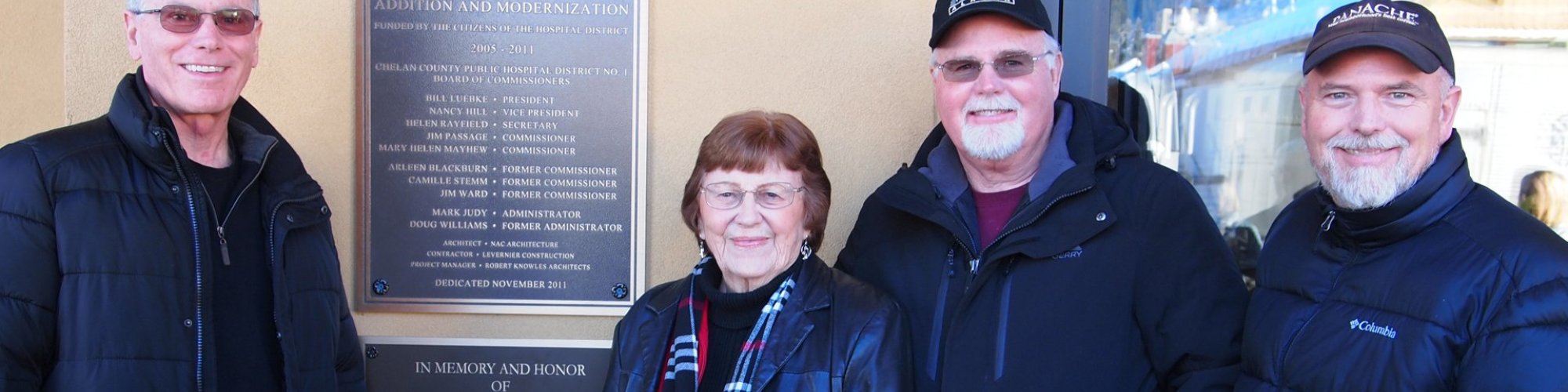 Jim Jr., Carol, Bob and Rich Adamson stand in front of a plaque dedicated to Jim Adamson, a founding member of the Cascade Medical Foundation.