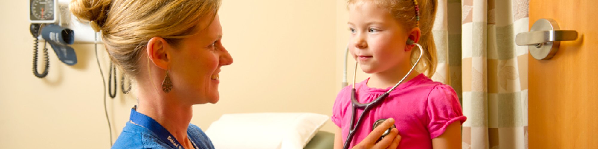 Carrie Kingsley, ARNP, checks the heartbeat of a pediatric patient.