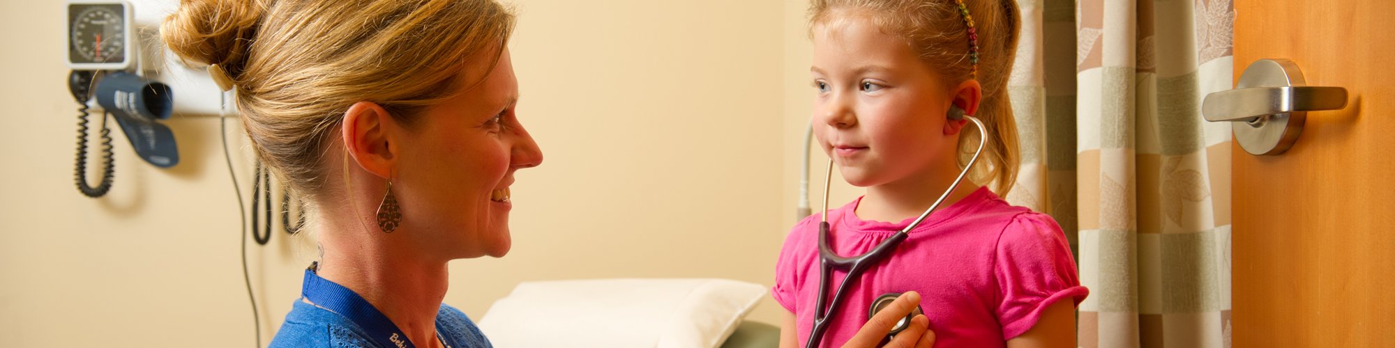 Carrie Kingsley, ARNP, checks the heartbeat of a pediatric patient.