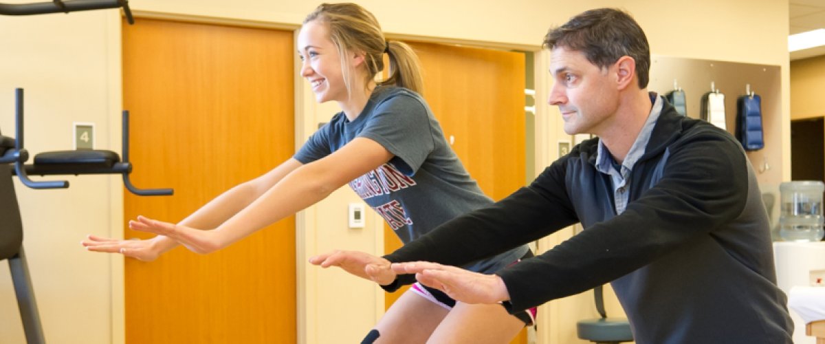 Physical Therapist Chris Allen works with Makenna, a high school athlete.
