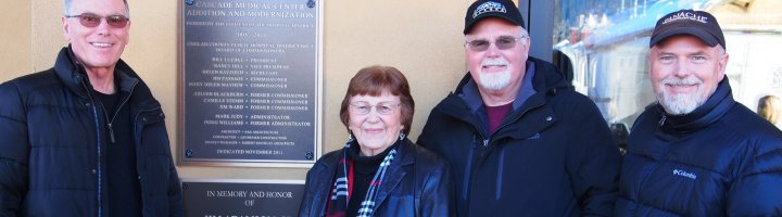 Jim Jr., Carol, Bob and Rich Adamson stand in front of a plaque dedicated to Jim Adamson, a founding member of the Cascade Medical Foundation.