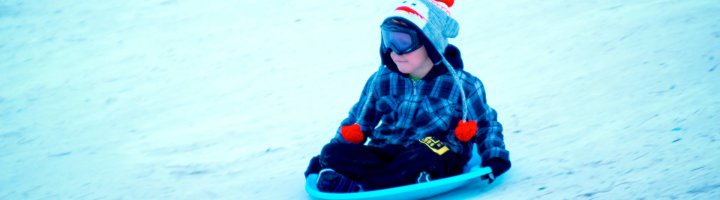 A boy sledding. 